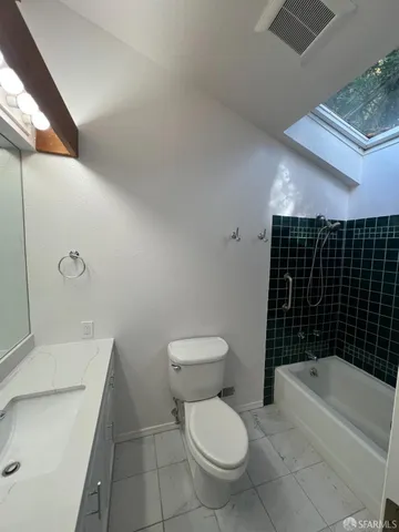 a bathroom with a sink a toilet and bathtub