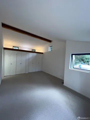 an empty room with a empty space and windows