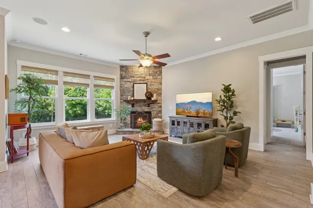 a living room with furniture a chandelier and a flat screen tv