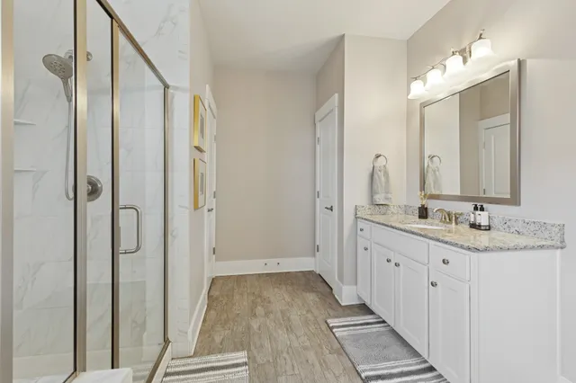 a bathroom with a double vanity sink and mirror