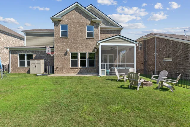 a backyard of a house with table and chairs