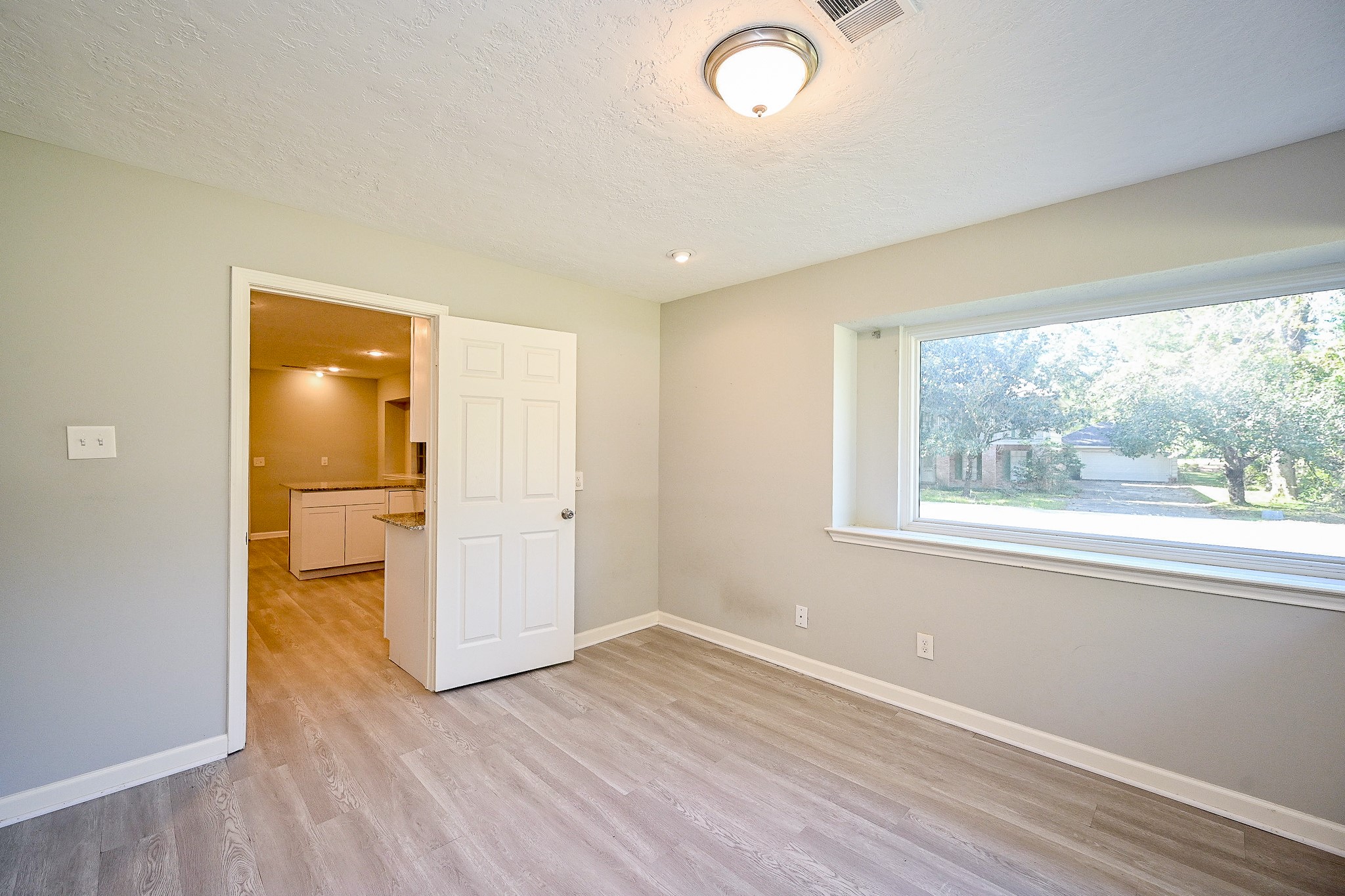 602 Mobile Court Conroe, TX 77302 - Photo 15 of 30 an empty room with wooden floor and windows