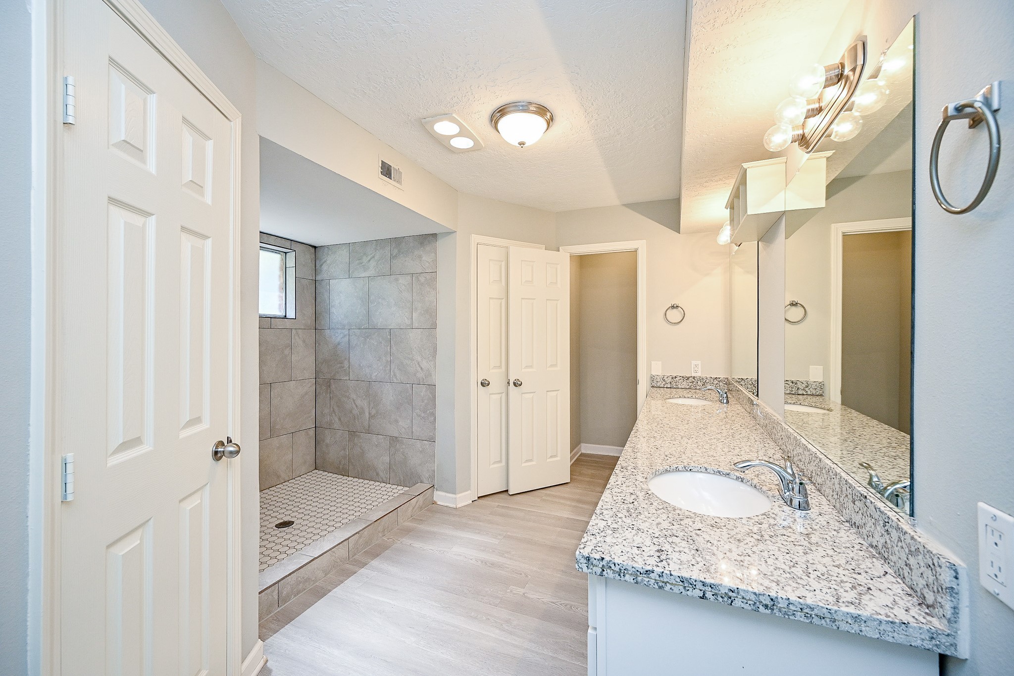602 Mobile Court Conroe, TX 77302 - Photo 19 of 30 a bathroom with a granite countertop sink and shower