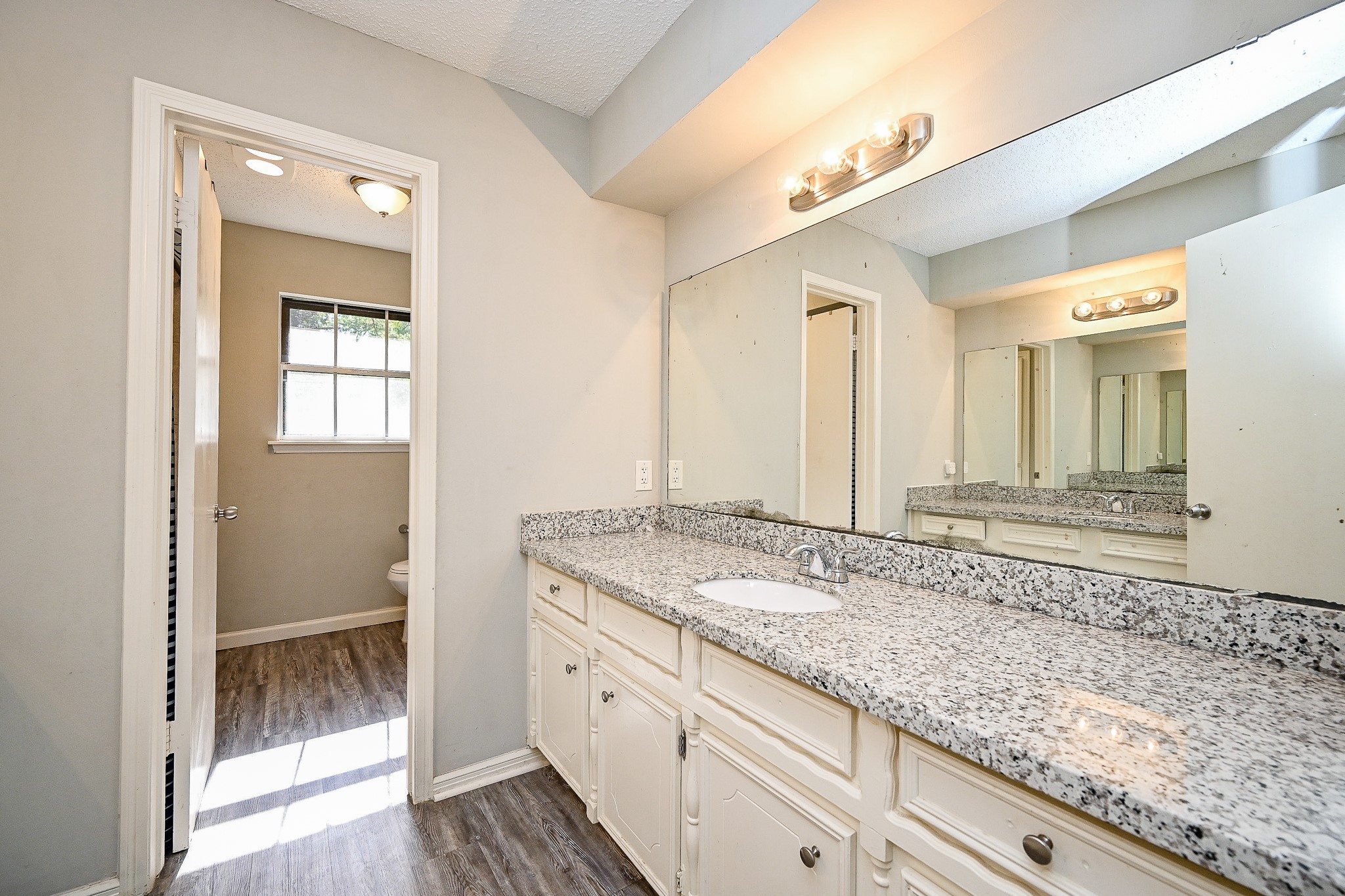 602 Mobile Court Conroe, TX 77302 - Photo 25 of 30 a bathroom with a granite countertop sink and a mirror