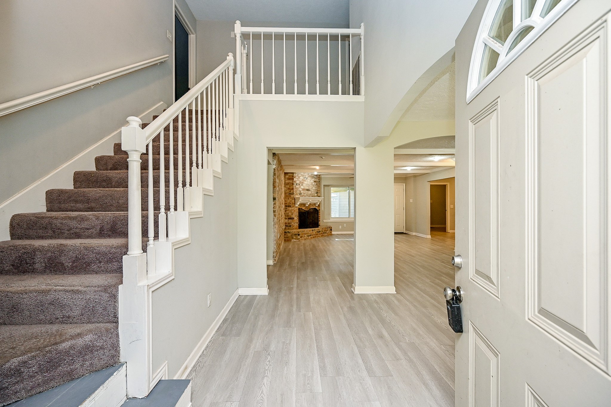 602 Mobile Court Conroe, TX 77302 - Photo 4 of 30 a view of a hallway with wooden floor and staircase