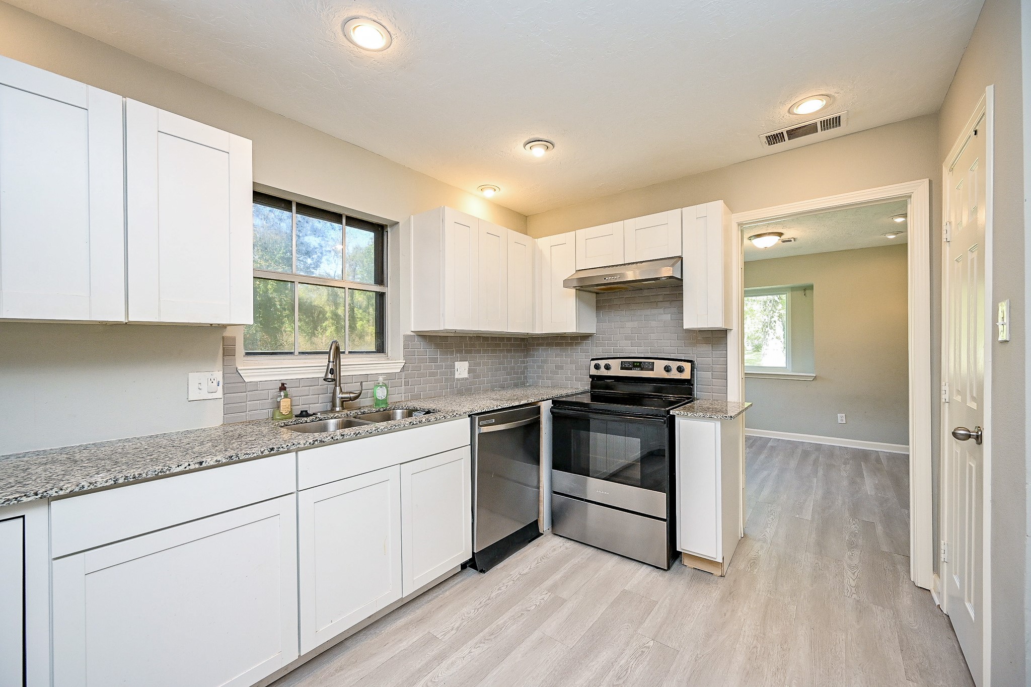 602 Mobile Court Conroe, TX 77302 - Photo 10 of 30 a kitchen with a sink stove and cabinets
