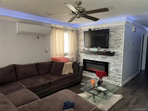 a living room with furniture a flat screen tv and a fireplace
