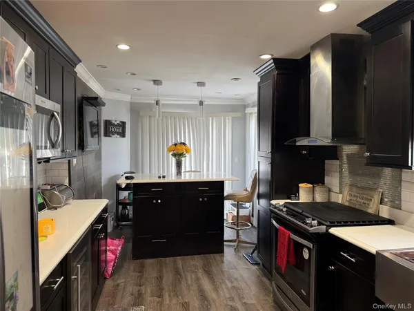 a kitchen with stainless steel appliances granite countertop a sink stove and refrigerator