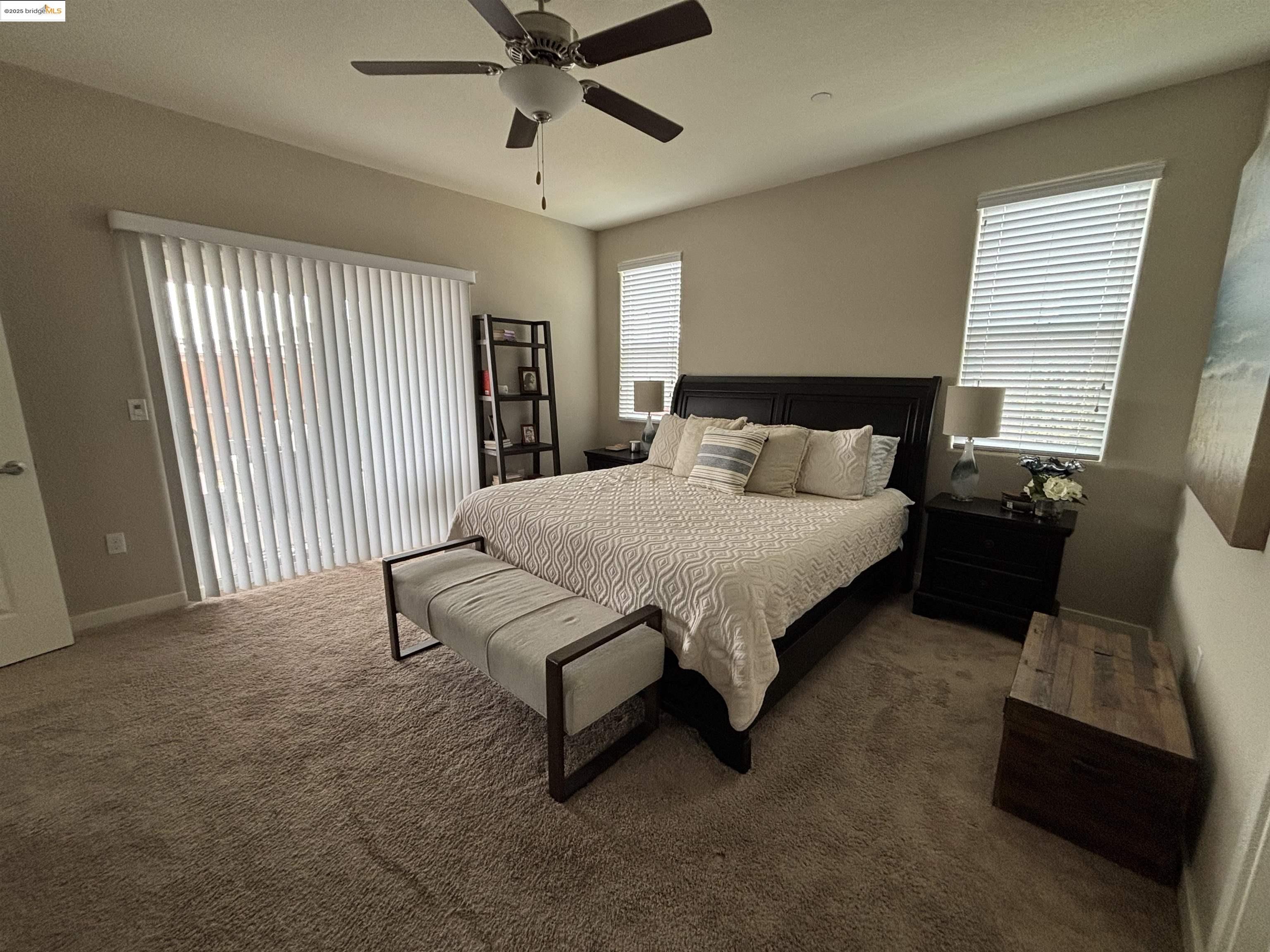 2107 Lavender Place Rio Vista, CA 94571 - Photo 19 of 45 a spacious bedroom with a bed and a chandelier