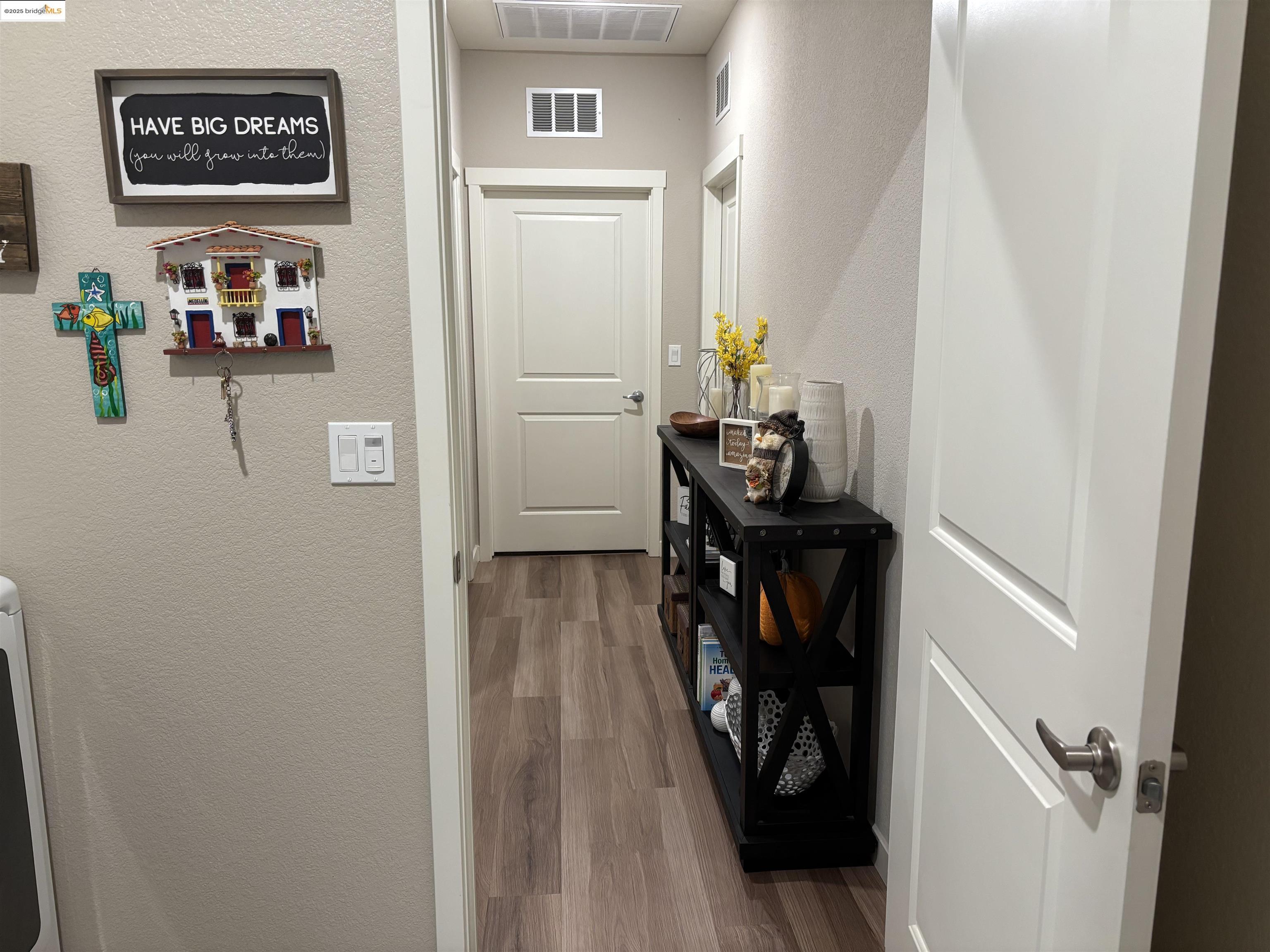 2107 Lavender Place Rio Vista, CA 94571 - Photo 20 of 45 a view of a hallway to a livingroom with wooden floor and furniture