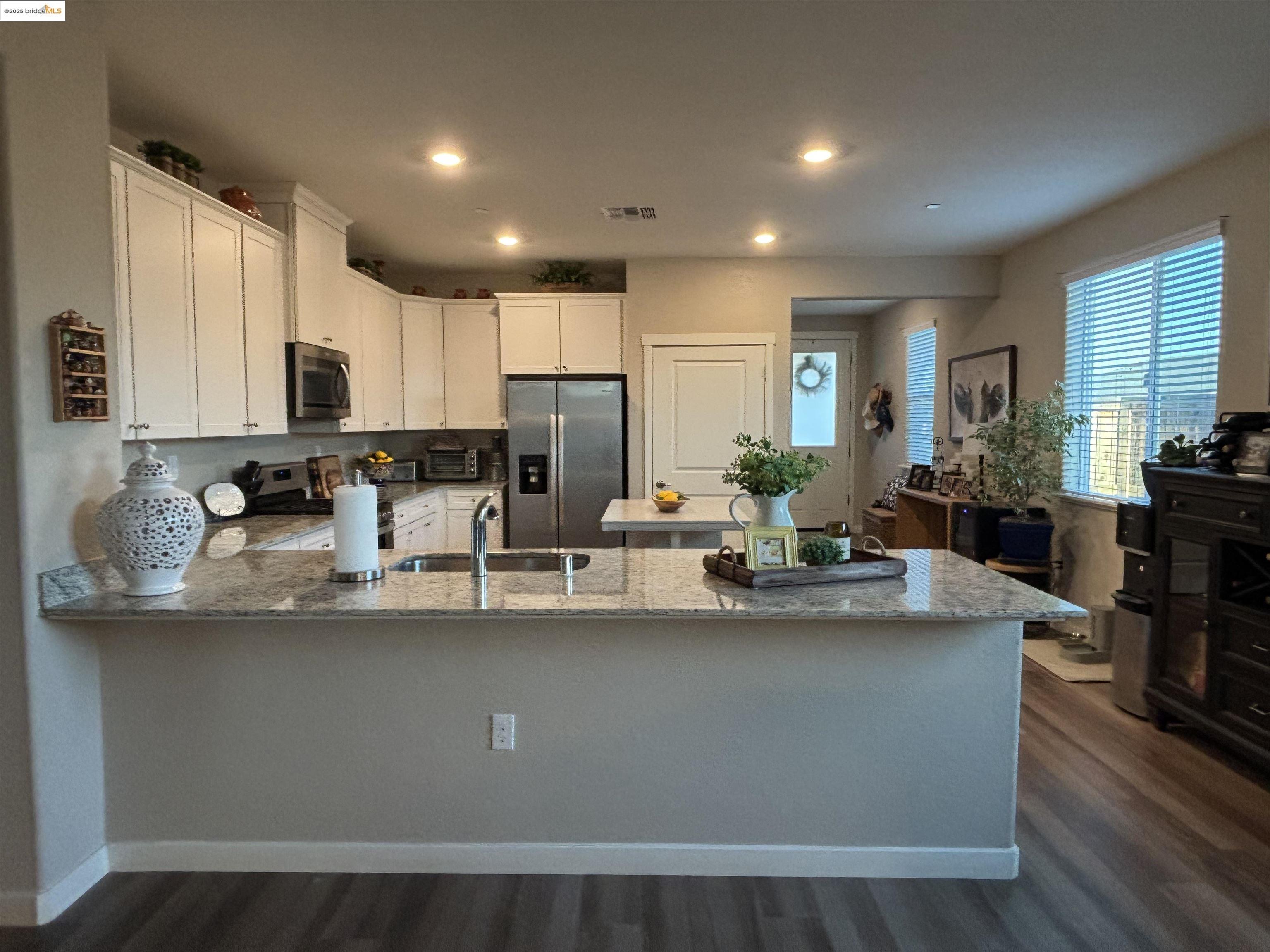 2107 Lavender Place Rio Vista, CA 94571 - Photo 6 of 45 a view of a kitchen with kitchen island stainless steel appliances a sink a stove a center island and cabinets