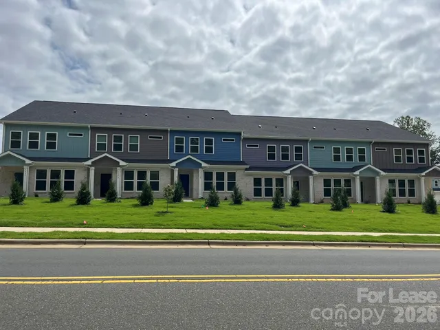 a front view of building with yard and green space