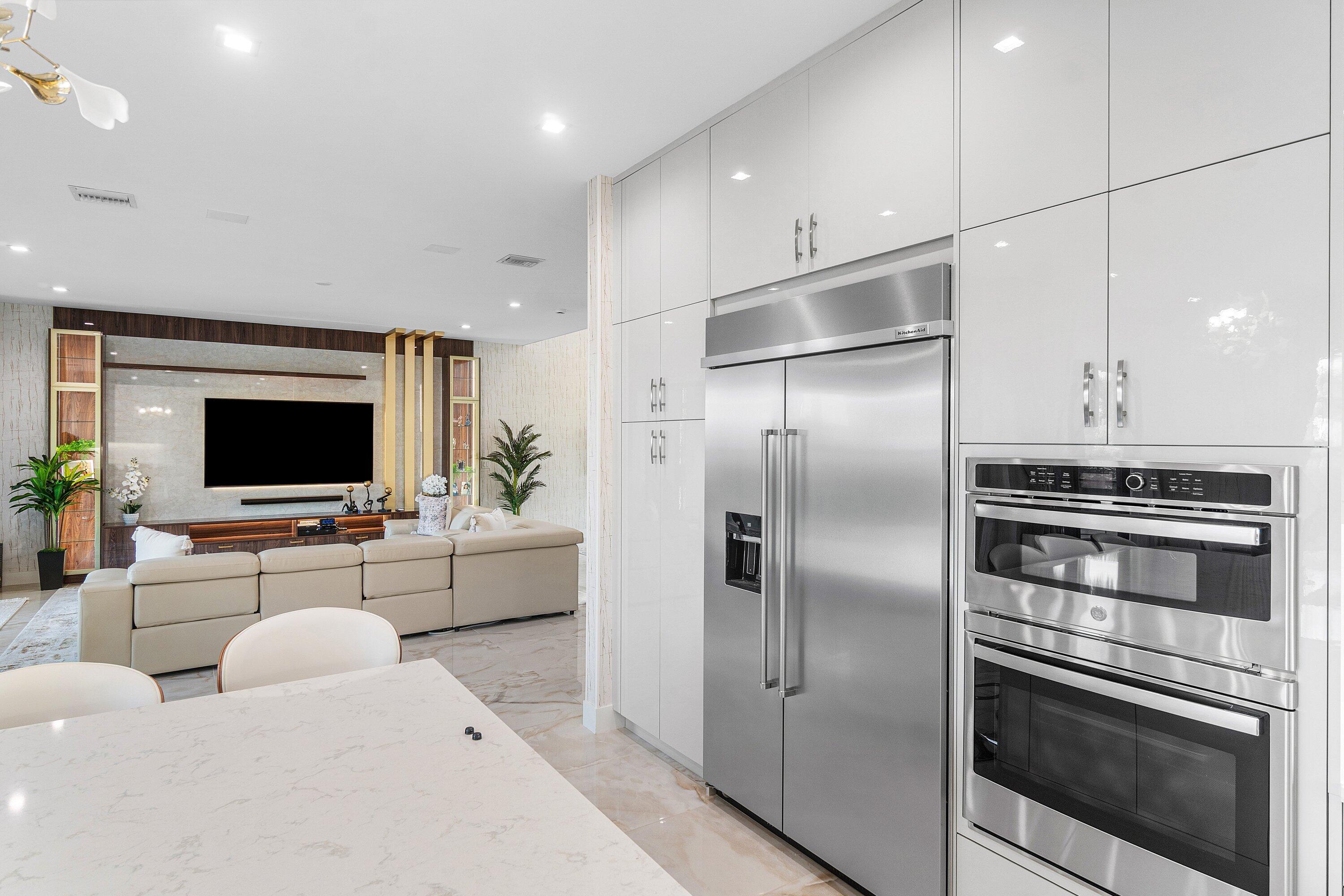 8233 Crystal Downs Avenue Boca Raton, FL 33434 - Photo 17 of 58 a living room with stainless steel appliances furniture a flat screen tv and a view of kitchen