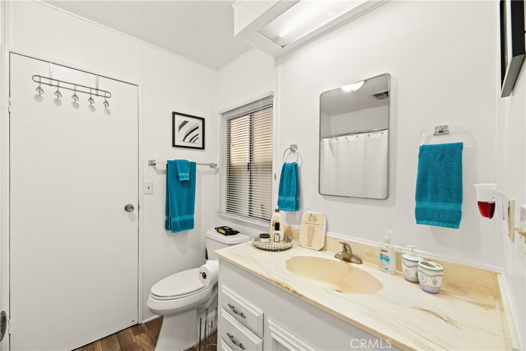 2964 Silver Oak Way Hemet, CA 92545 - Photo 25 of 60 a bathroom with a granite countertop toilet sink and mirror