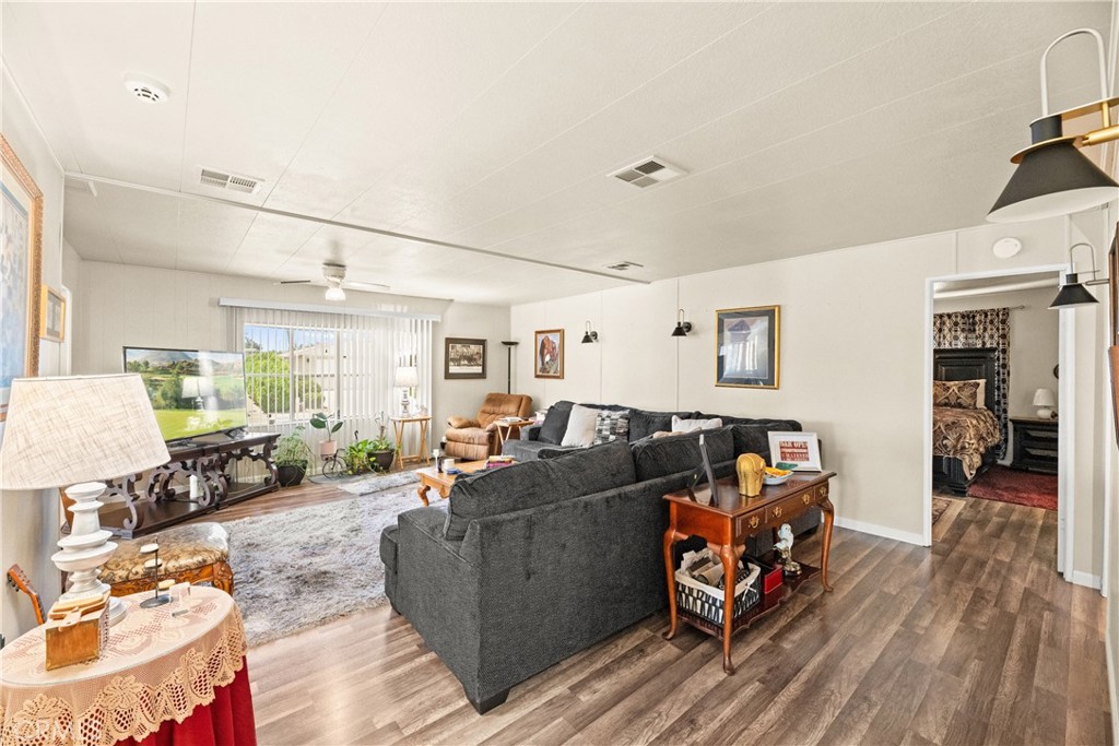 2964 Silver Oak Way Hemet, CA 92545 - Photo 26 of 60 a living room with furniture and a wooden floor