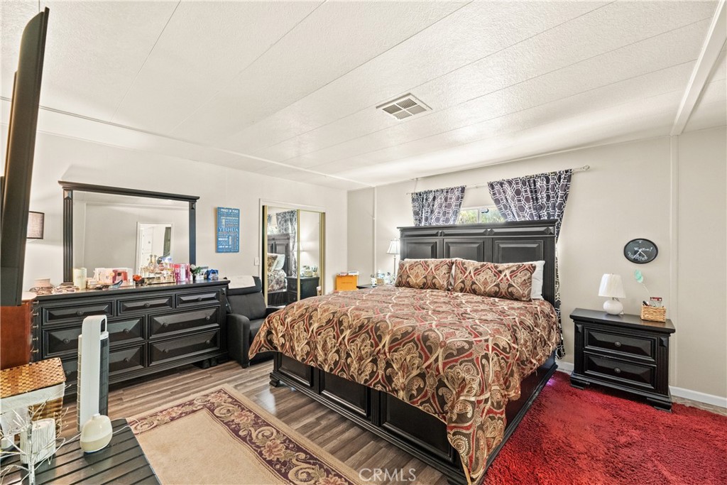 2964 Silver Oak Way Hemet, CA 92545 - Photo 30 of 60 a bedroom with a bed and wooden floor