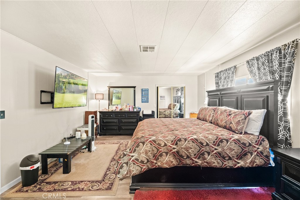 2964 Silver Oak Way Hemet, CA 92545 - Photo 32 of 60 a bedroom with a bed and wooden floor