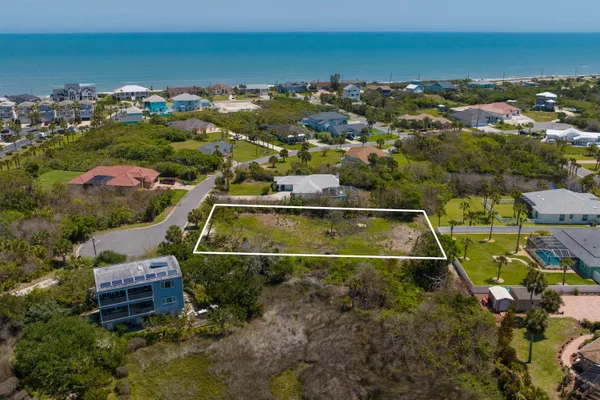 an aerial view of a house with a ocean view
