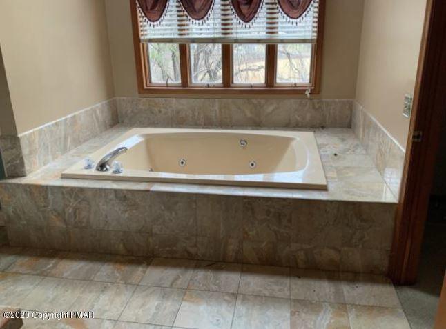 400 Blue Ridge Road Saylorsburg, PA 18353 - Photo 10 of 13 a bath tub sitting next to a window