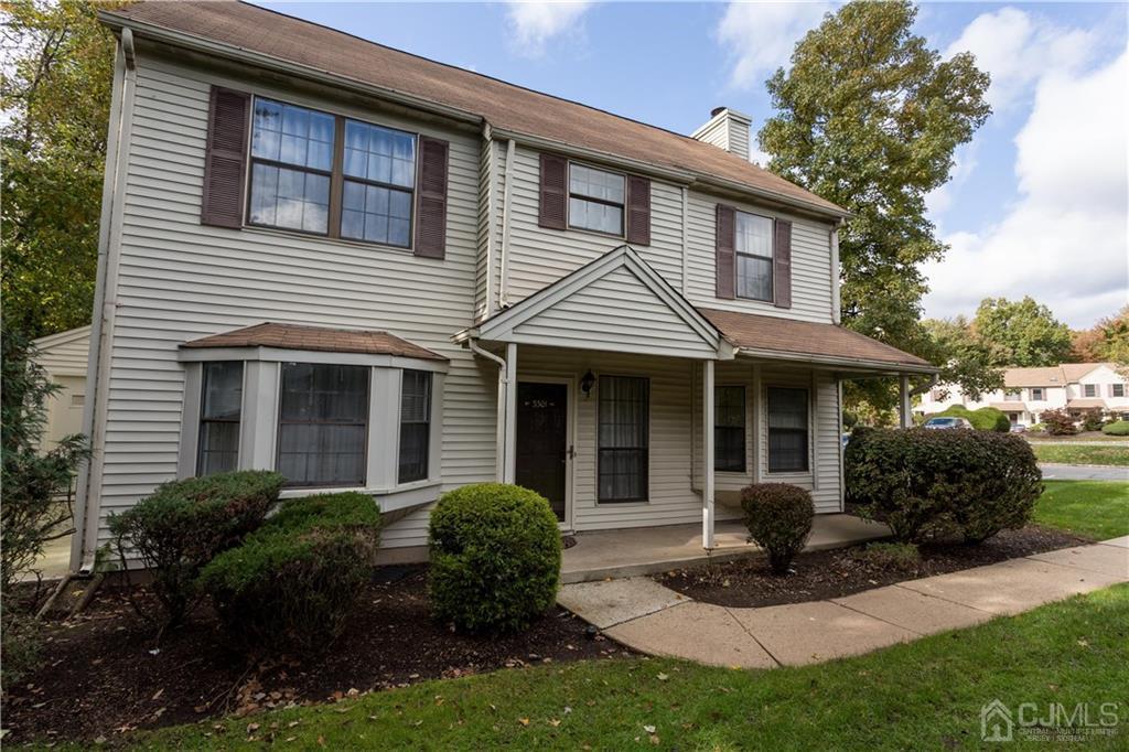 3301 Stonehedge Road, Unit 3301 Edison, NJ 08820 - Photo 3 of 25 a front view of a house with a yard table and chairs