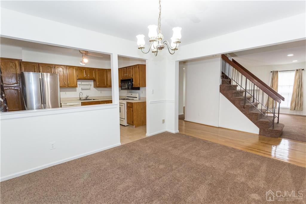3301 Stonehedge Road, Unit 3301 Edison, NJ 08820 - Photo 5 of 25 a view of livingroom with chandelier