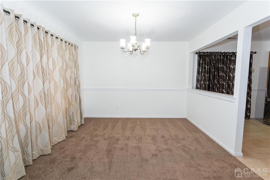 3301 Stonehedge Road, Unit 3301 Edison, NJ 08820 - Photo 6 of 25 a view of a chandelier in an empty room