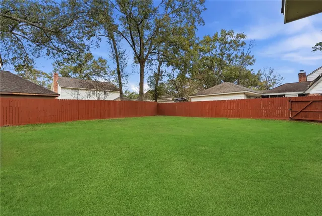 a view of green field with house in the background