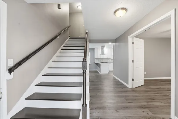 a view of an entryway with wooden floor