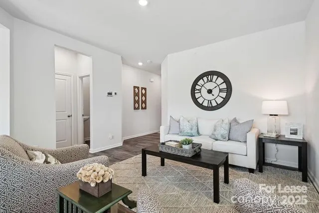 a living room with furniture a rug and a wall painting