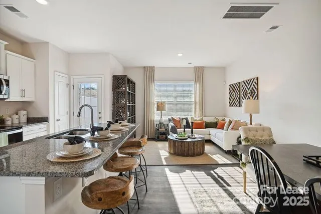 a living room with furniture and floor to ceiling window