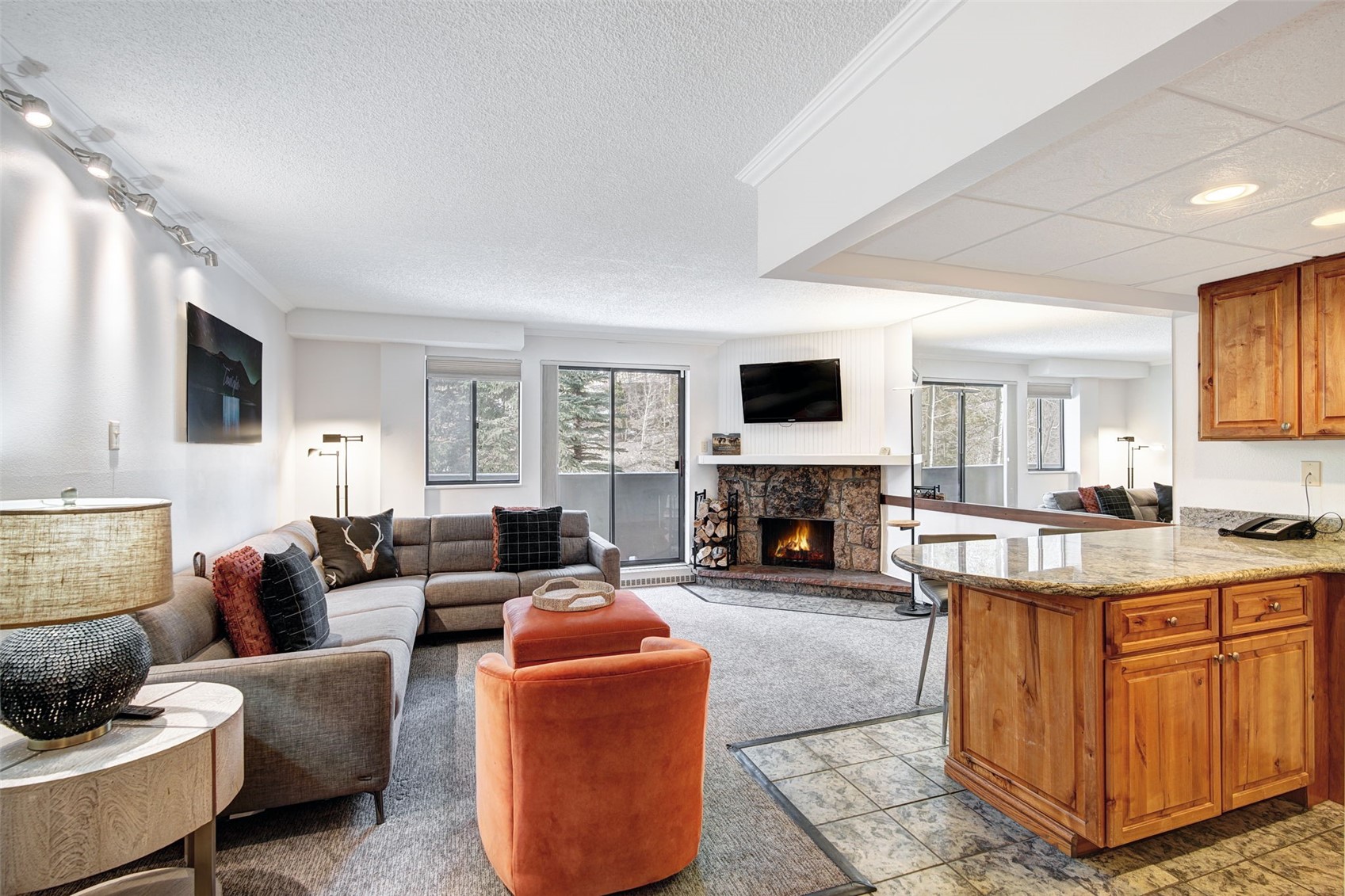 a living room with furniture a fireplace and a flat screen tv