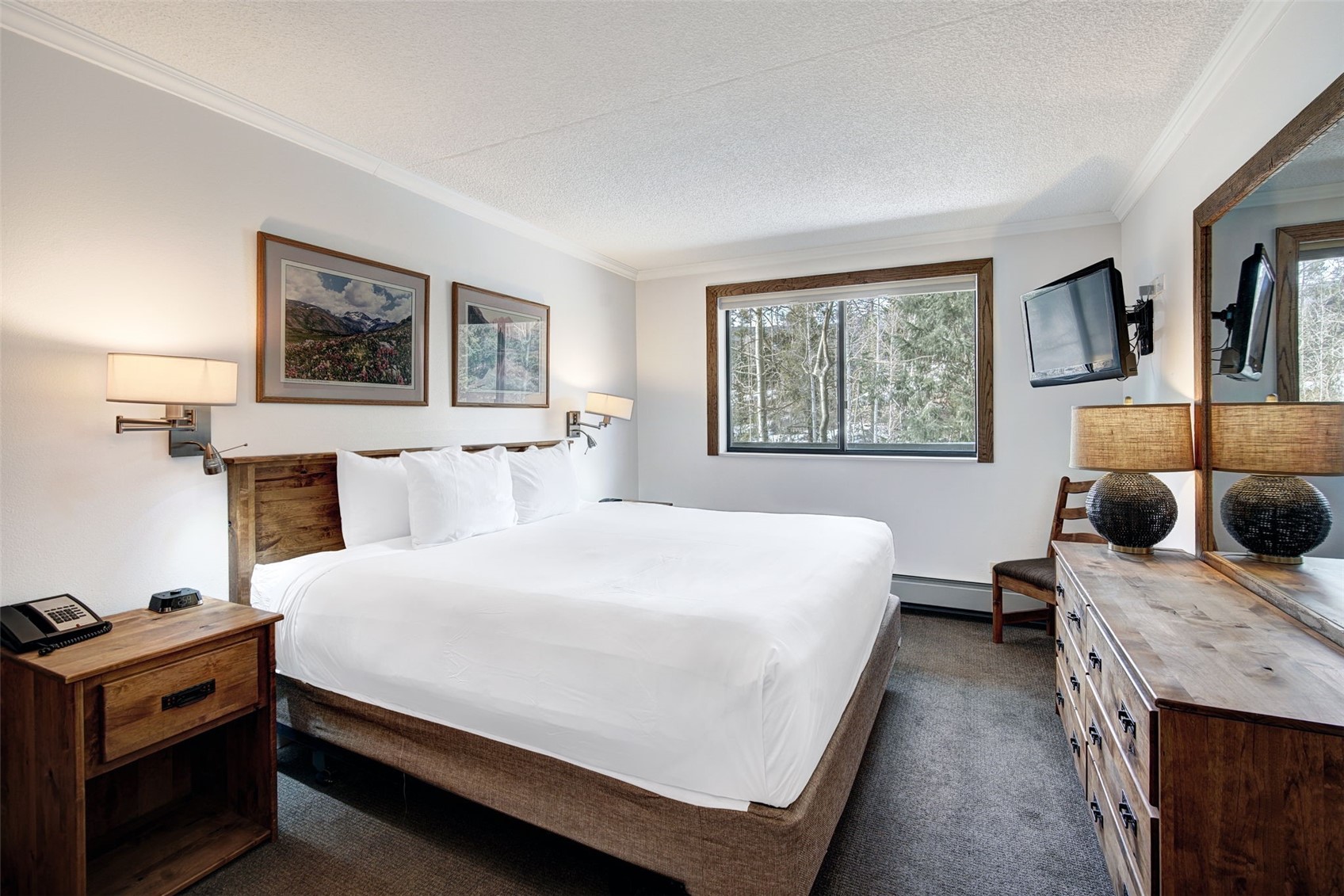 631 Village Road, Unit 31460 Breckenridge, CO 80424 - Photo 8 of 20 a bedroom with a bed and wooden floor