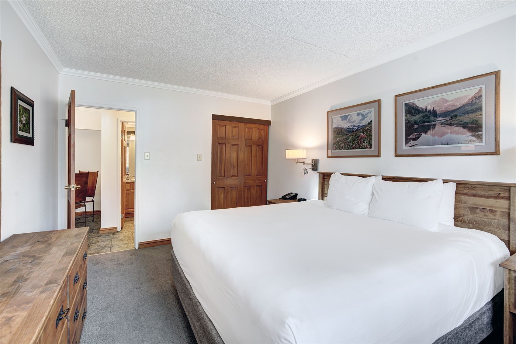 631 Village Road, Unit 31460 Breckenridge, CO 80424 - Photo 9 of 20 a bedroom with a large bed and a chandelier