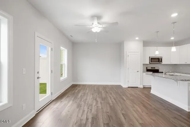 a view of kitchen with sink and wooden floor