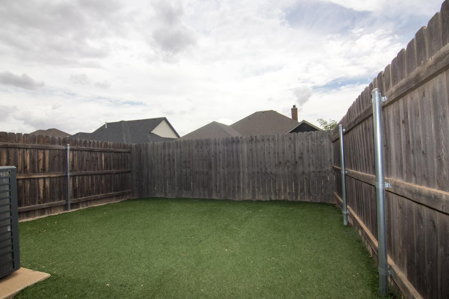 3821 133rd Street Lubbock, TX 79423 - Photo 11 of 15 a view of a backyard with wooden fence