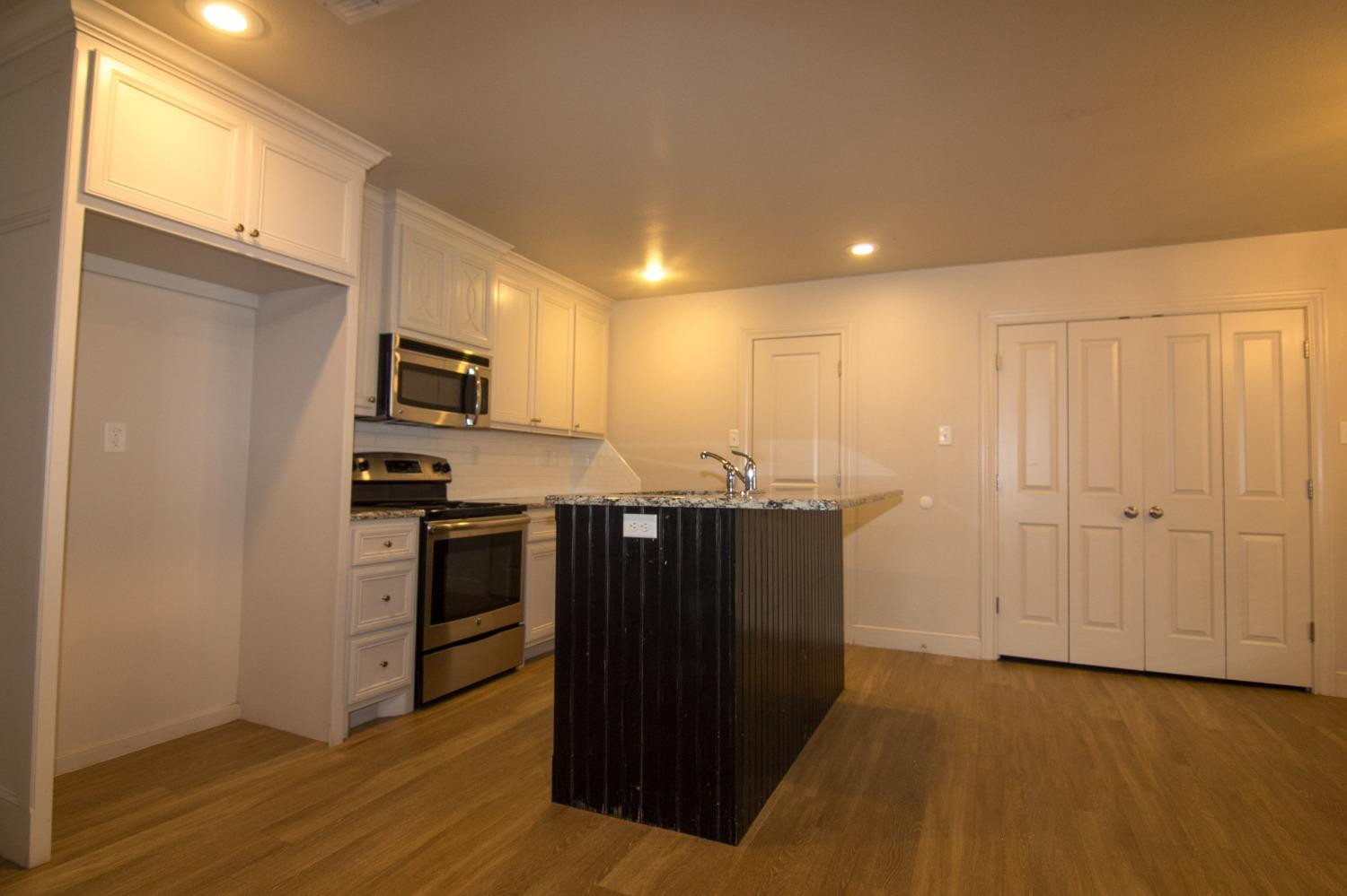 3821 133rd Street Lubbock, TX 79423 - Photo 13 of 15 a kitchen with stainless steel appliances a refrigerator and a stove top oven