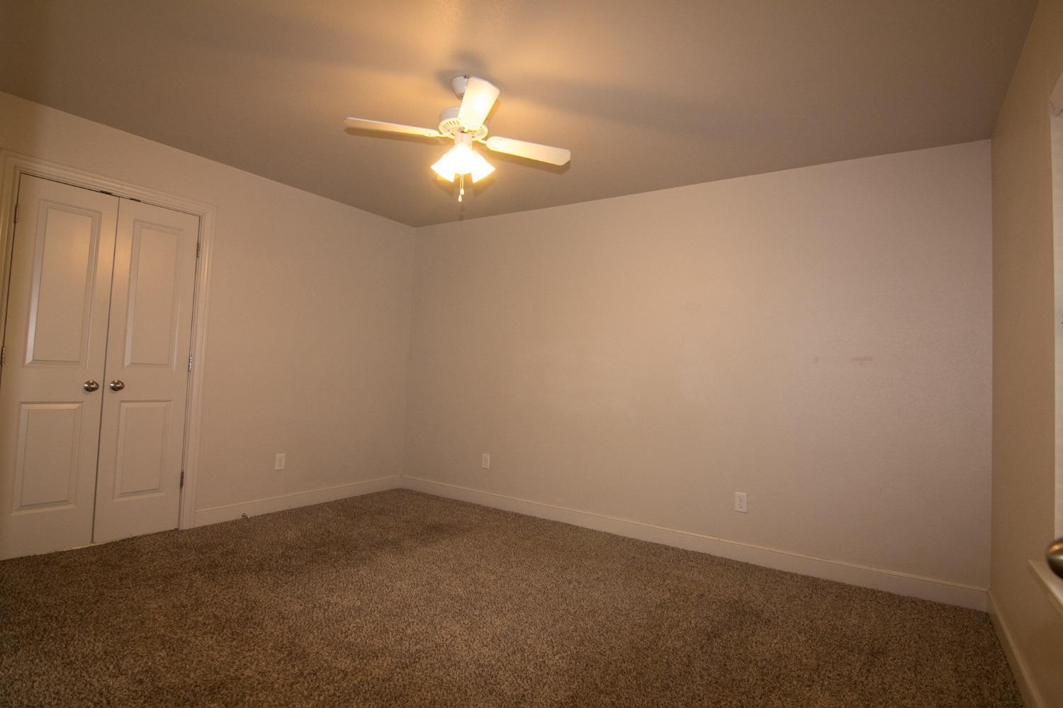 3821 133rd Street Lubbock, TX 79423 - Photo 5 of 15 an empty room with a chandelier fan