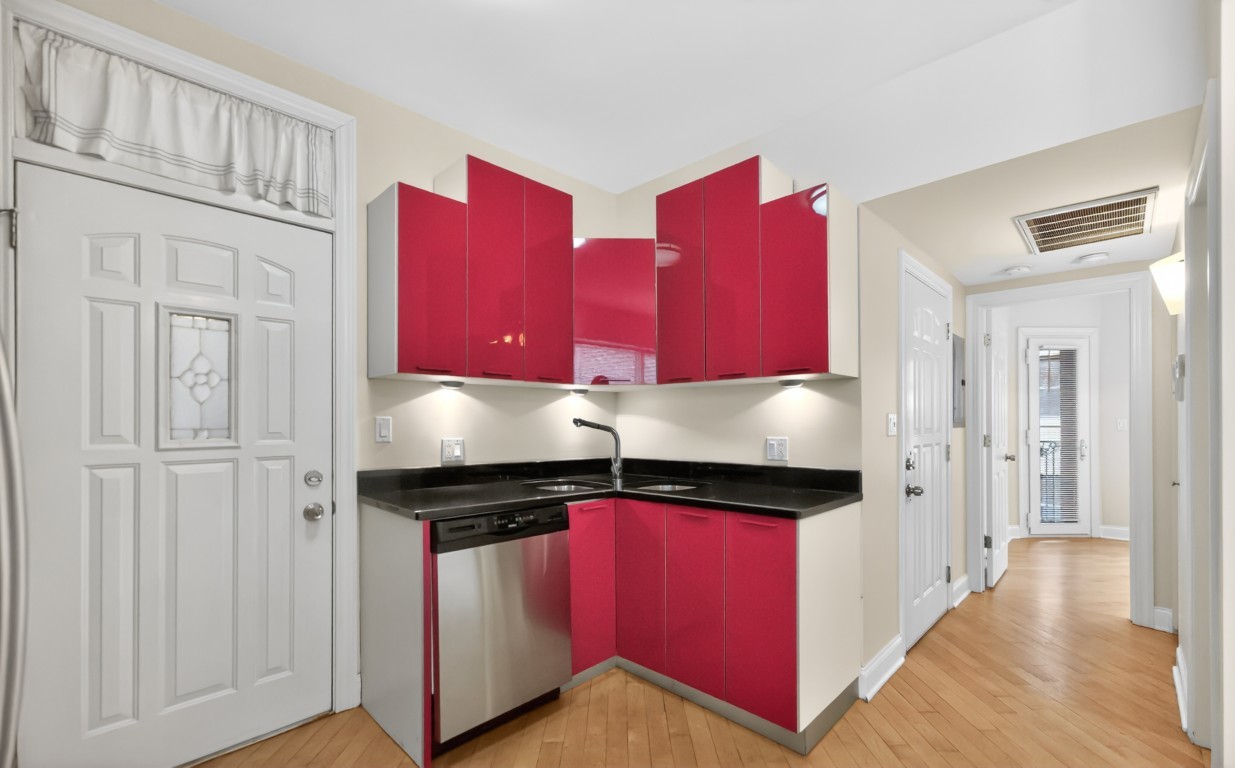 906 West Winona Street, Unit 2S Chicago, IL 60640 - Photo 5 of 15 a kitchen with stainless steel appliances granite countertop a red stove top oven a refrigerator with wooden cabinets