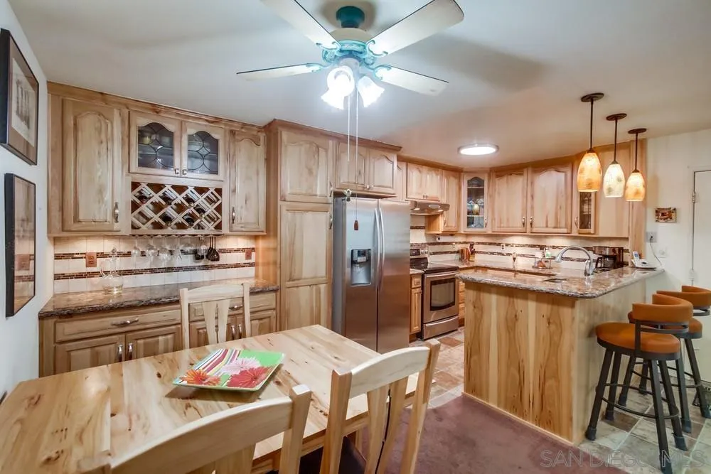 3583 Ruffin Road, Unit 209 San Diego, CA 92123 - Photo 1 of 39 a kitchen with refrigerator cabinets dining table and chairs
