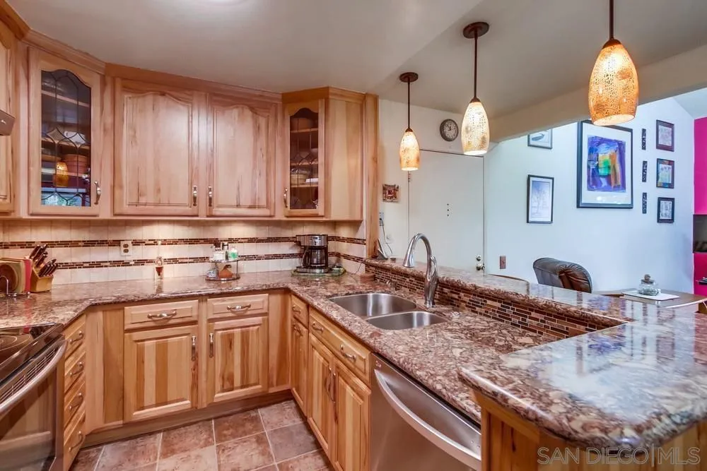 3583 Ruffin Road, Unit 209 San Diego, CA 92123 - Photo 11 of 39 a kitchen with stainless steel appliances granite countertop a sink a stove and a wooden cabinets