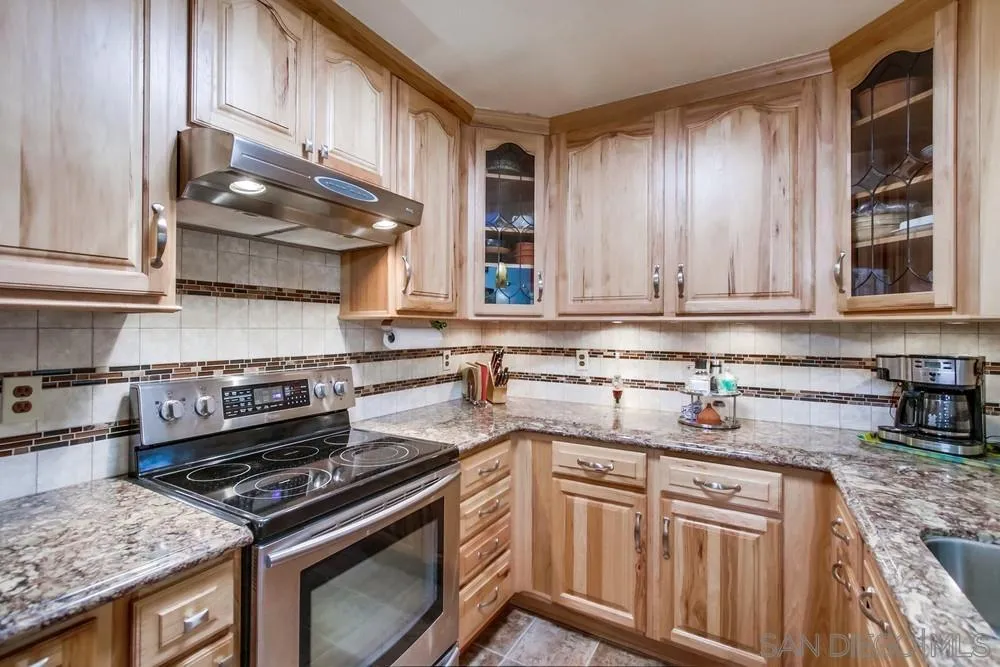 3583 Ruffin Road, Unit 209 San Diego, CA 92123 - Photo 12 of 39 a kitchen with stainless steel appliances granite countertop a stove a sink and a microwave