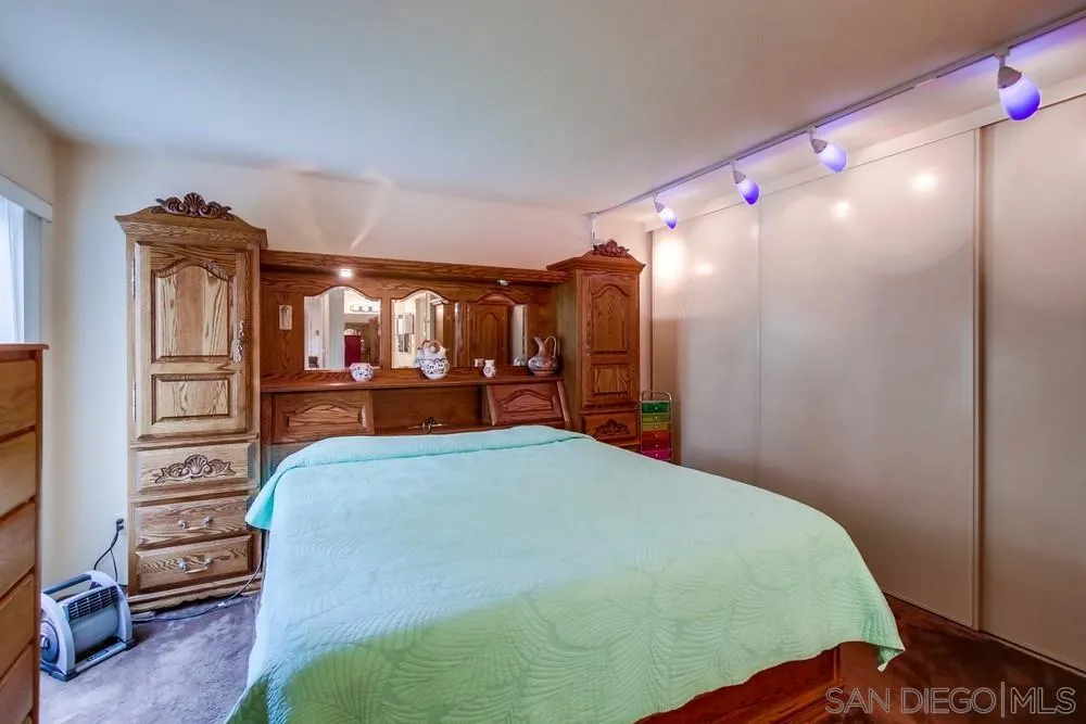 3583 Ruffin Road, Unit 209 San Diego, CA 92123 - Photo 13 of 39 a bedroom with a bed and a mirror