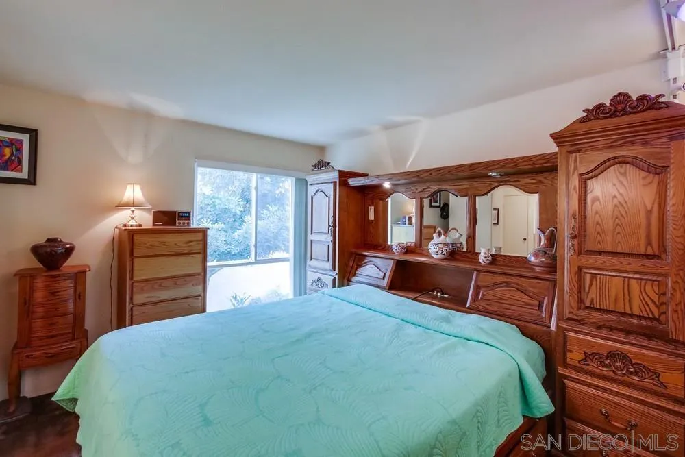 3583 Ruffin Road, Unit 209 San Diego, CA 92123 - Photo 14 of 39 a bedroom with a bed and wooden floor