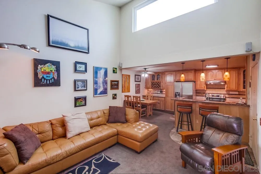 3583 Ruffin Road, Unit 209 San Diego, CA 92123 - Photo 2 of 39 a living room with furniture a rug and kitchen view