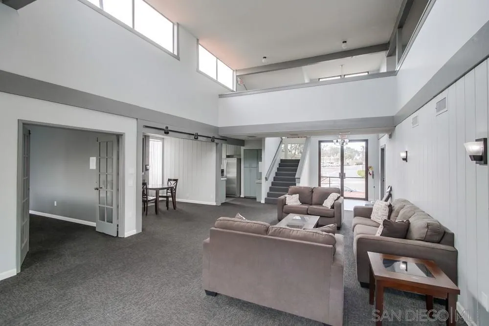 3583 Ruffin Road, Unit 209 San Diego, CA 92123 - Photo 30 of 39 a living room with furniture and large windows