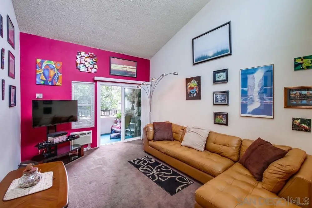 3583 Ruffin Road, Unit 209 San Diego, CA 92123 - Photo 3 of 39 a living room with furniture a flat screen tv and a couch