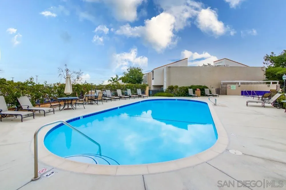 3583 Ruffin Road, Unit 209 San Diego, CA 92123 - Photo 35 of 39 a view of a swimming pool with lawn chairs under an umbrella