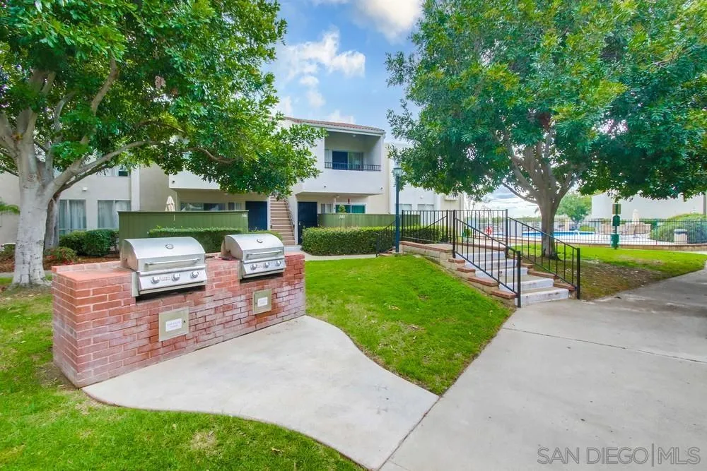 3583 Ruffin Road, Unit 209 San Diego, CA 92123 - Photo 39 of 39 a view of a backyard with couches plants and large tree
