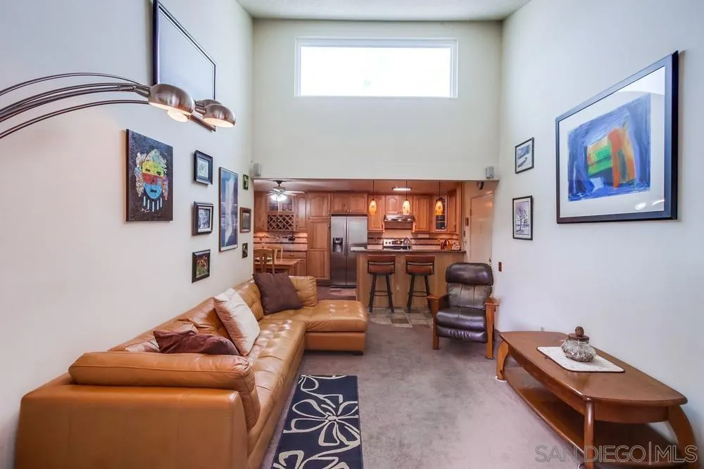 3583 Ruffin Road, Unit 209 San Diego, CA 92123 - Photo 5 of 39 a living room with furniture a rug and a window