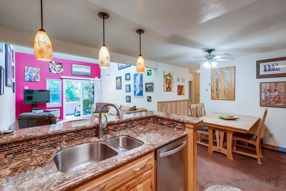 3583 Ruffin Road, Unit 209 San Diego, CA 92123 - Photo 6 of 39 a kitchen with a sink a counter top space and living room view